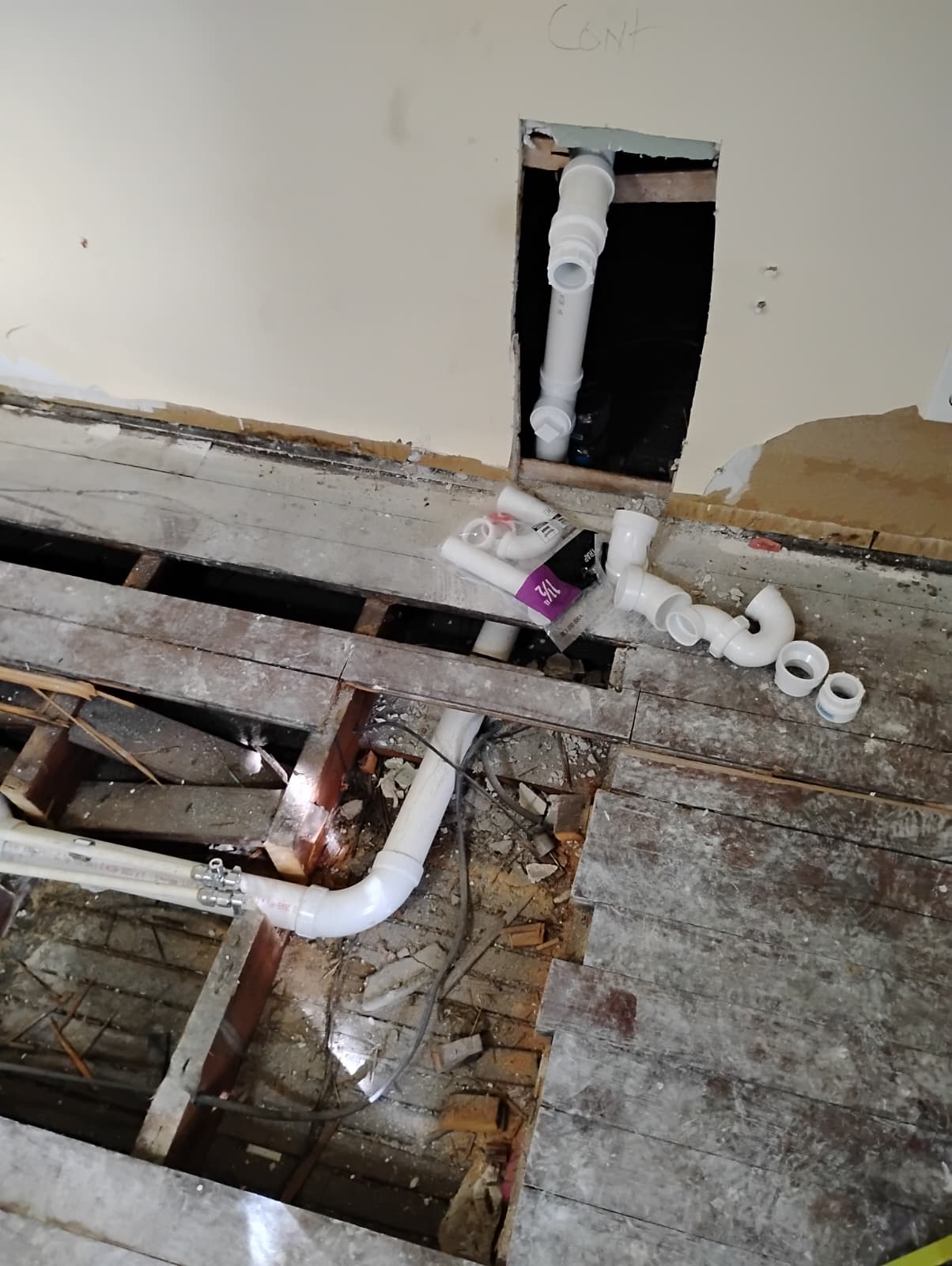 New drain piping run beneath the opened floor